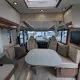 Intérieur d'un camping-car moderne avec table et sièges en cuir beige